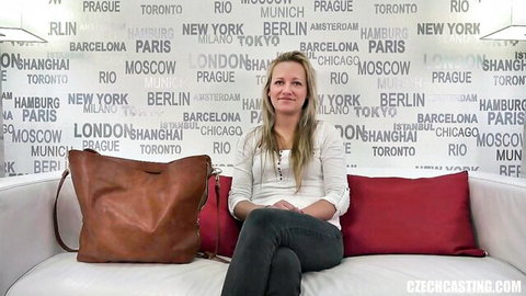 Amateur blonde Czech Casting model in white blouse and jeans, casual seated pose