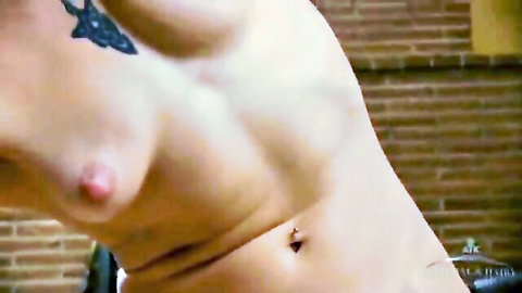 Curvy Caucasian MILF topless with tattoo and nipple piercing closeup