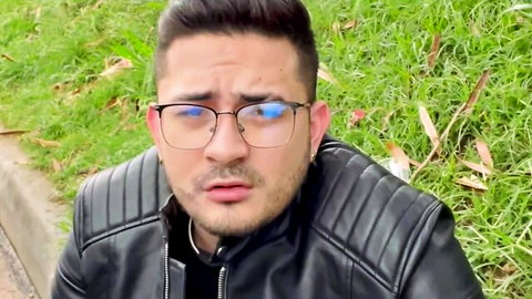 Latino man in blue glasses and leather jacket outdoors, eyeing biker chick for paid wild ride