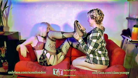 MTF tomboy in lingerie dominated by girlfriend on couch, legs up in fishnets