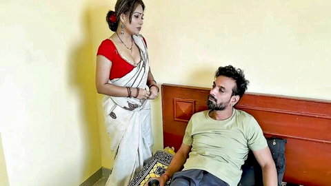 Curvy Indian housewife in red blouse white saree teases cleavage to man lying on bed