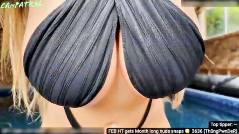 Blonde with huge tits in draped top poses by pool in webcam show