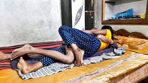 Indian couple in intense homemade spooning sex with her yellow top and blue pants pulled down