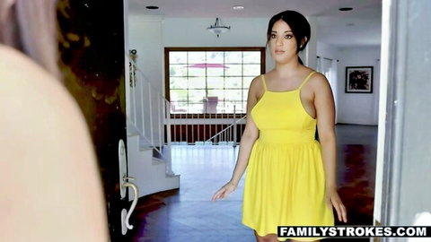 Brunette teen babe in tight yellow sundress standing in home doorway