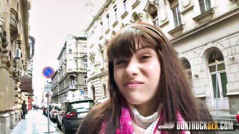 Luna Rival smirks on urban street in pink scarf for hot casting tease