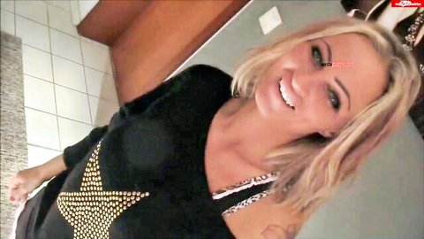 Sweetpinkpussy smiling seductively in black studded top, big tits tease