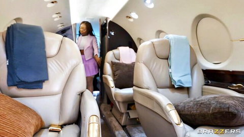 Ebony babe in tight purple dress standing in luxury private jet cabin Brazzers