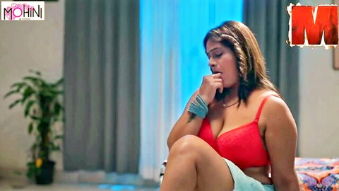 Curvy Indian babe in red bra and shorts seductively biting finger showing huge tits cleavage