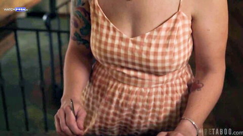 Siri Dahl in low-cut checkered dress teasing cleavage with tattoos