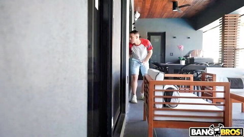 Leana Lovings in red tank top and blue shorts peeking outside casually