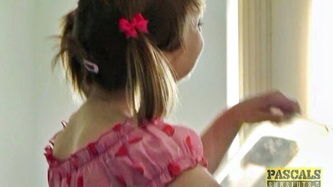 Cherry English in pink pigtail dress by window, teasing view