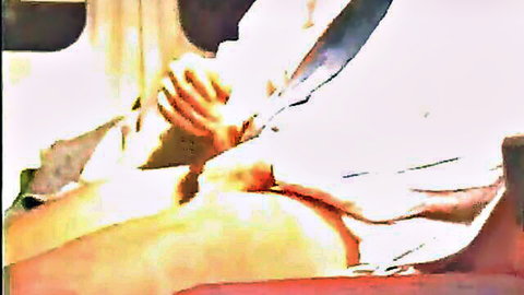 Muscular hand stroking erect cock with foreskin pulled back in gay closeup