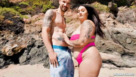 Curvy tattooed Euro BBW in skimpy pink bikini with hunk on sunny beach