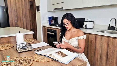 Curvy brunette with big tits and deep cleavage checks phone at kitchen table