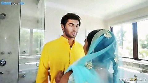 Handsome Indian guy in yellow kurta embraces curvy brunette babe in blue dupatta in steamy bathroom
