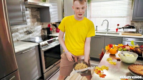 Redhead guy in yellow tee cooking Thanksgiving meal in kitchen, Reality Kings teaser