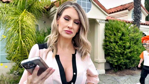 Gigi Dior blonde MILF in low-cut blouse checking phone outdoors