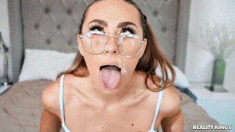 Mackenzie Mace tongue out with cumshot, glasses on, petite blonde in blue top