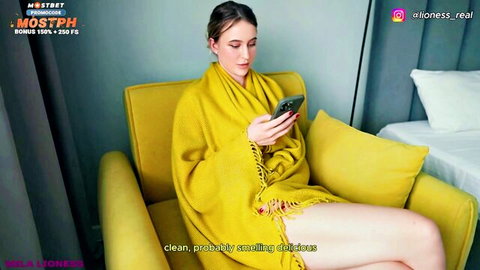 Seductive blonde mature in yellow shawl, teasing with phone