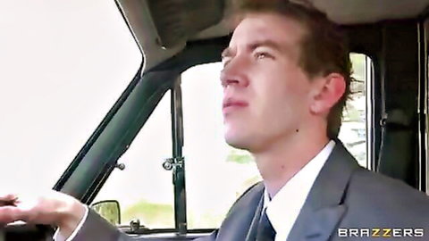 Suited man driving car, looking pensive in Donna Bell's Brazzers anal scene