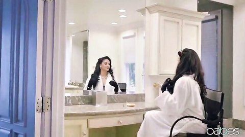 Sheena Ryder in white robe at vanity mirror, sexy bedroom tease