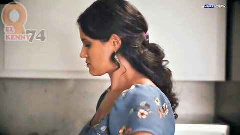 Penny Barber in submissive pose wearing floral blue off-shoulder dress