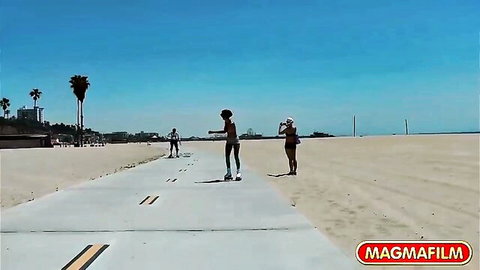 Tattooed brunette Bonnie Rotten roller skating at sunny beach in short shorts