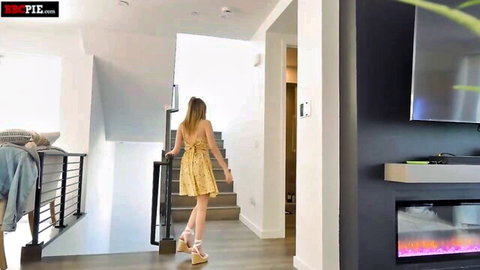 Skylar Valentine in sexy yellow dress ascending stairs