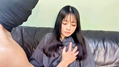 Masked man groping petite Asian babe's tits through shirt on couch