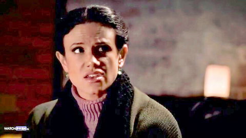 Surprised brunette MILF with open mouth wearing pink turtleneck and fur collar jacket