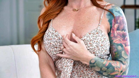 Sophia Locke redhead with tattoos teases cleavage in floral top