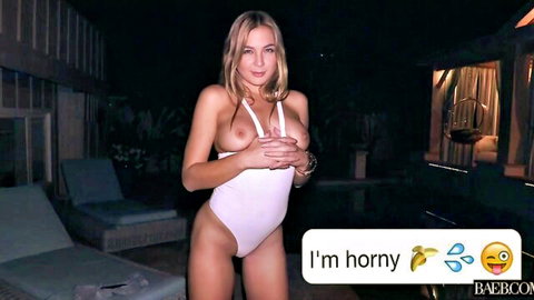 Blair Williams teasing horny in white bodysuit, hands over breasts