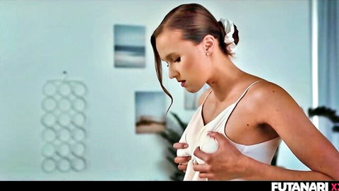 Futanari woman in white slip dress sensually holding her breasts