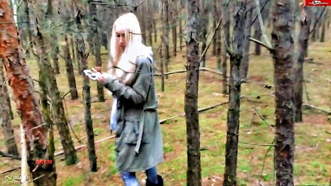 Blonde LauraParadise lost in forest, wearing green coat and jeans
