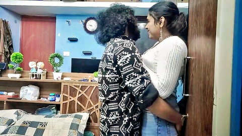 Indian couple in steamy embrace, man hugging sexy woman from behind against door in bedroom
