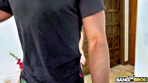 Guy in black shirt pulls down girl's pink panties exposing her bare ass cheeks indoors