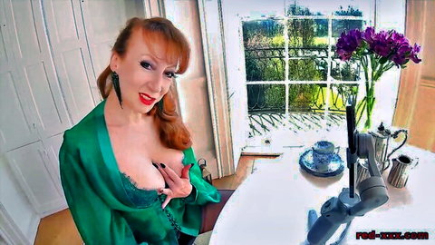 Redhead cougar in green satin top teasing cleavage closeup