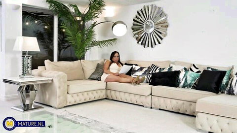 Alana B lounging seductively in white dress, mature MILF tease