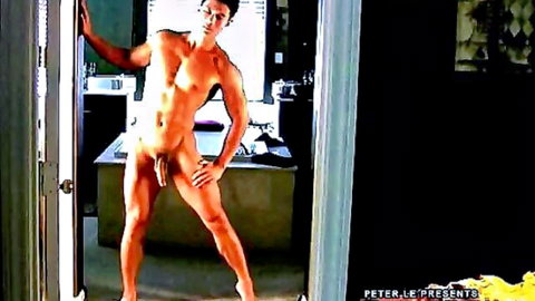 Muscular Asian stud poses fully nude in doorway flaunting his thick cock and balls