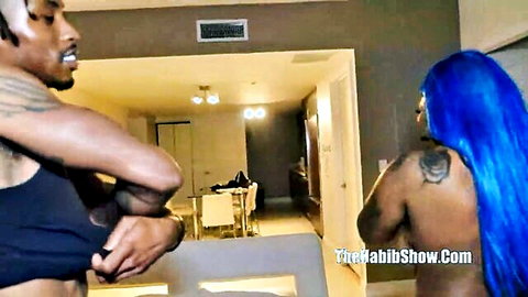 Thick ebony woman with blue hair stands nude as tattooed black man grabs her big ass from behind