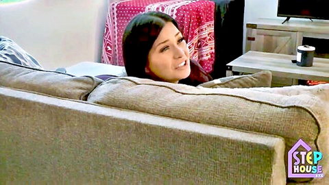 London Rose as hot MILF smiling on couch in stuck fetish scene
