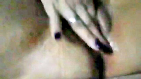 Blurry close-up of mature hairy pussy with manicured hand touching