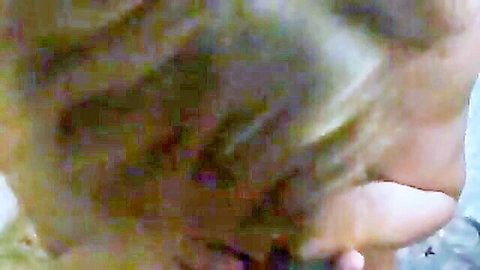 Close-up of mature brunette woman sucking cock intimately