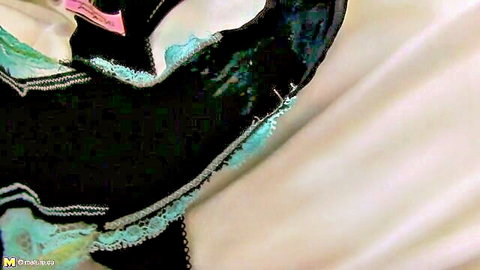 Close-up of mature sexy black and teal lace lingerie on bed