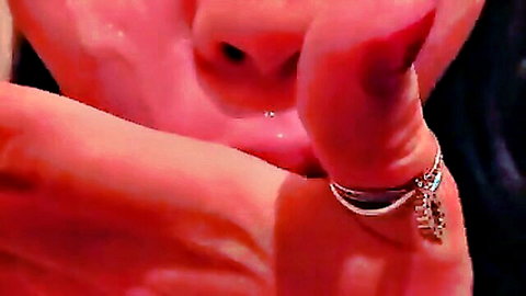 Close-up of Asian woman with cum on glossy lips and piercing, seductive kiss