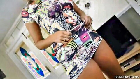 British girl stripping in tight colorful dress, teasing pose
