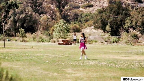 Jane Wilde and Gabbie Carter in pink skirts running outdoors