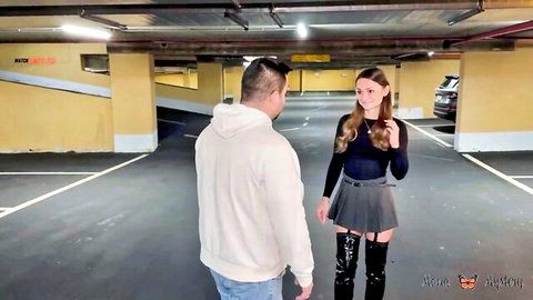 Brunette in mini skirt garter stockings and thigh-high boots teases guy in underground parking garage