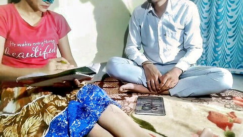 Indian educator Avni in red top and skirt with student during study session