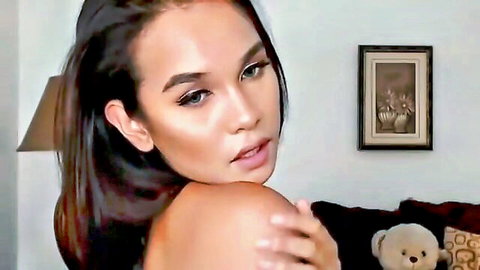 Stunning transgender bombshell with long dark hair and seductive gaze